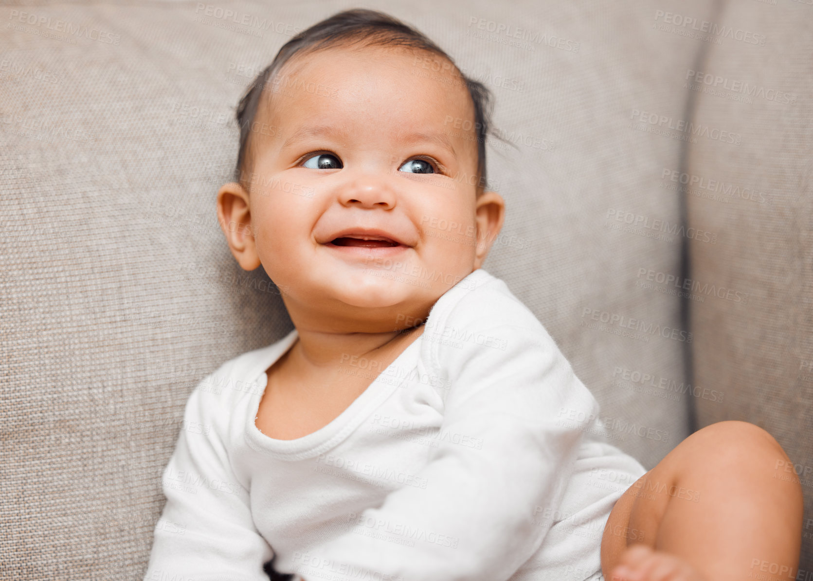 Buy stock photo Shot of an adorable baby girl sitting on the couch at home