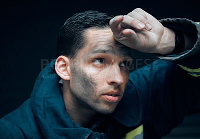 Buy stock photo Working, firefighter or man with job in studio, thinking and planning for rescue operation. Fireman, idea and thoughtful for emergency response, accident and disaster in uniform by black background