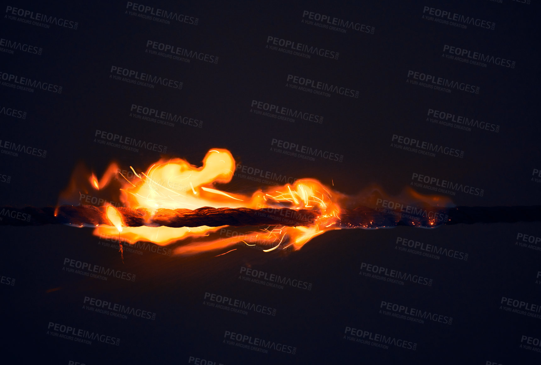 Buy stock photo Fire, small and flame on black background in nature with heat, sparks and rope for light or energy. Hot, hell and burning for bonfire, barbecue and fireplace start at night with risk or danger 