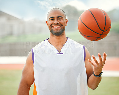 Buy stock photo Cropped portrait of a handsome young male basketball player standing outside with a basketball in hand