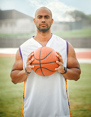 Buy stock photo Cropped portrait of a handsome young male basketball player standing outside with a basketball in hand