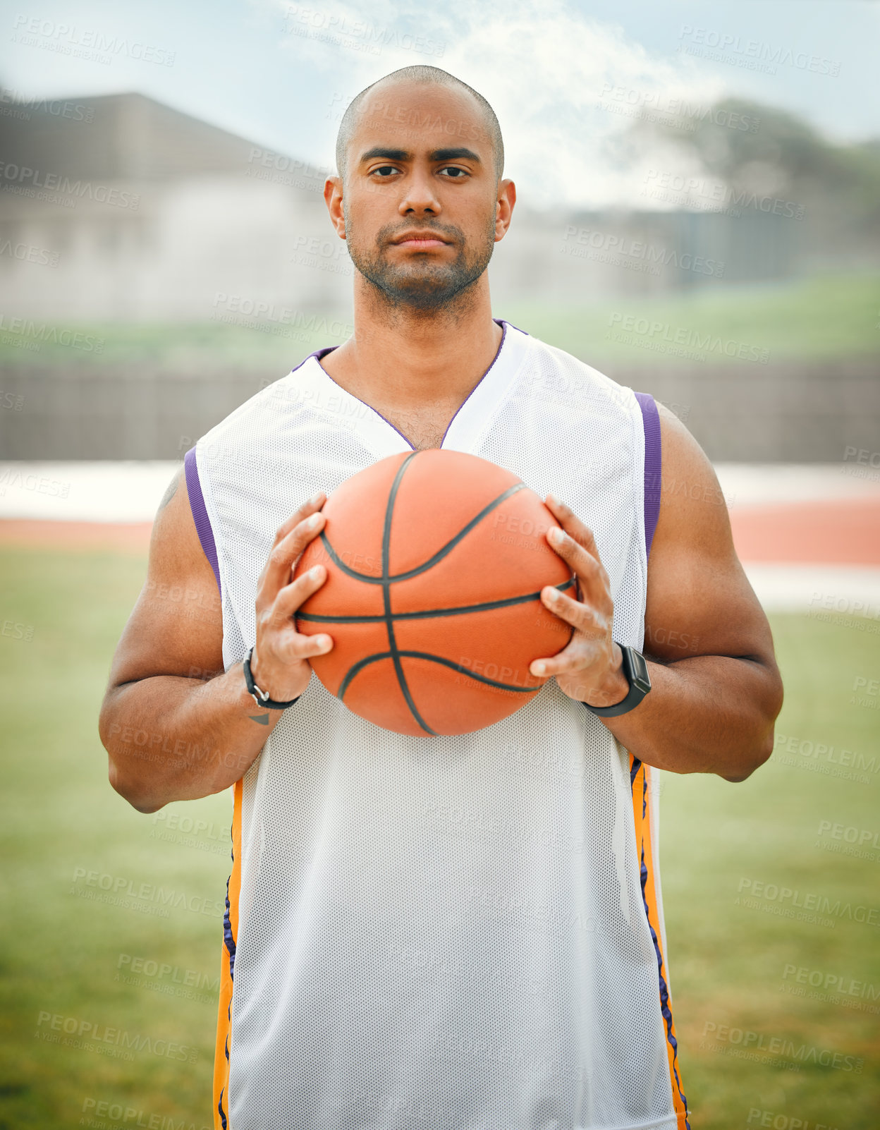 Buy stock photo Cropped portrait of a handsome young male basketball player standing outside with a basketball in hand