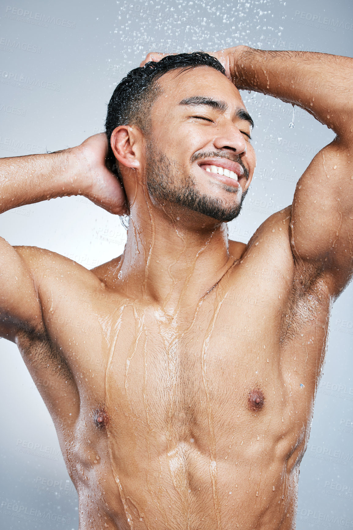 Buy stock photo Man, water and shower on body for cleaning, skincare and wash on white studio background with smile. Male model, happiness and hygiene with clear liquid for facial, wellness and self care in bathroom