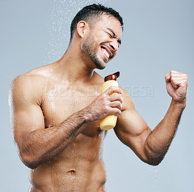 Buy stock photo Studio shot of a handsome young man singing in the shower against a grey background