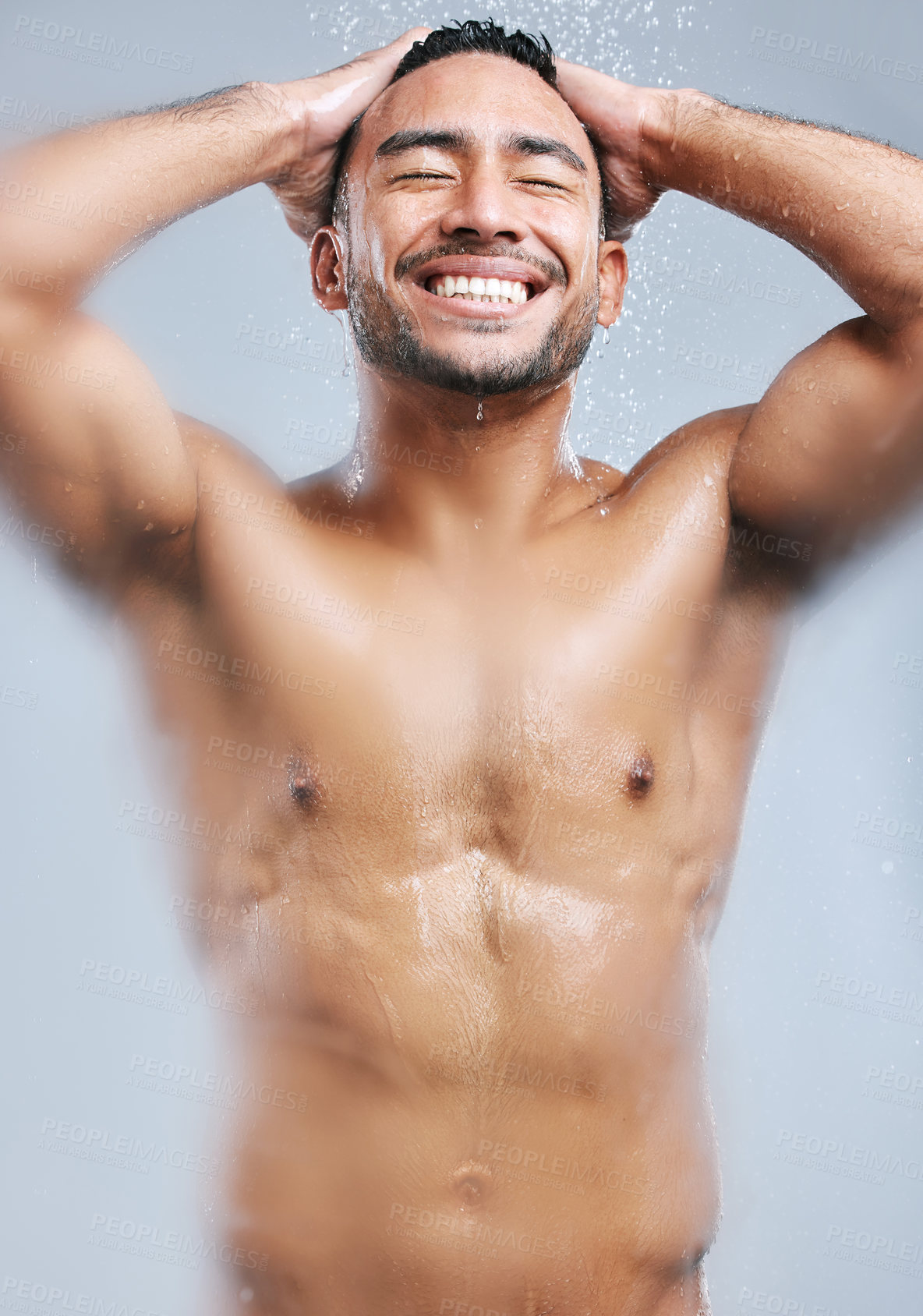 Buy stock photo Man, shower and water on body for cleaning, wash and skincare on white studio background with smile. Male model, happiness and hygiene with clear liquid for facial, wellness and self care in bathroom