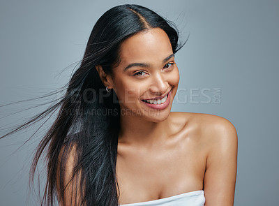 Buy stock photo Studio portrait of an attractive young woman posing against a grey background