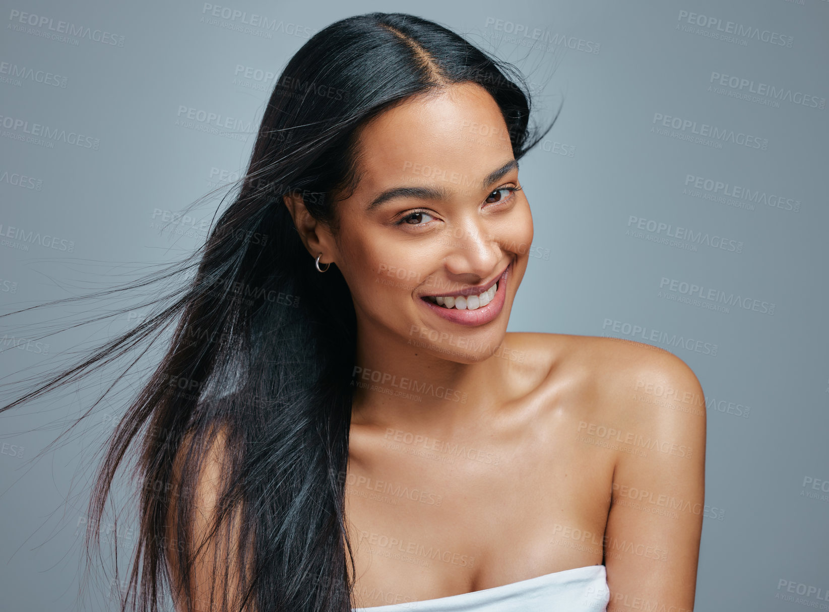 Buy stock photo Studio portrait of an attractive young woman posing against a grey background