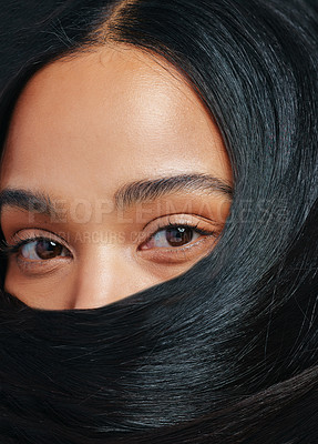 Buy stock photo Studio portrait of an attractive young woman posing with her hair covering her face