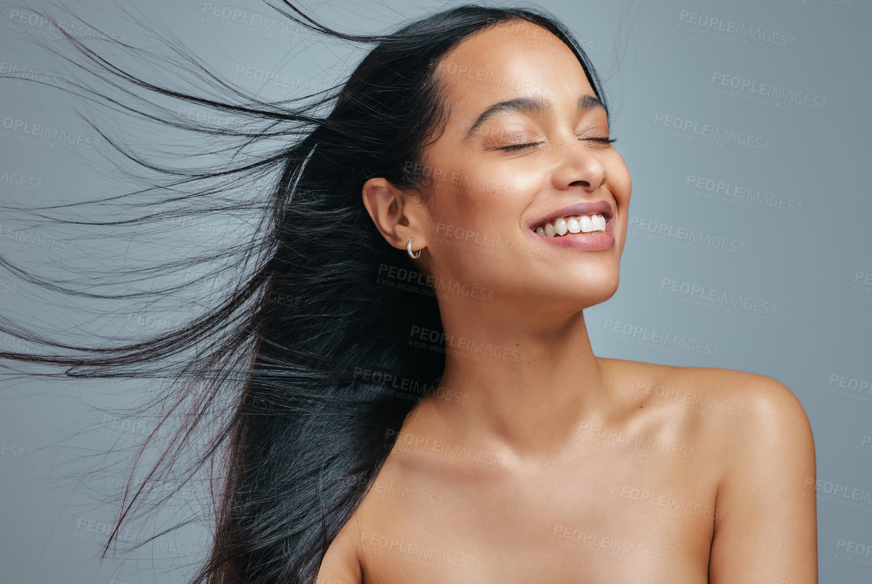 Buy stock photo Studio shot of an attractive young woman posing against a grey background