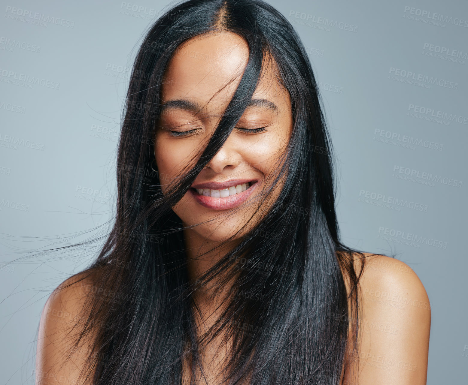 Buy stock photo Studio shot of an attractive young woman posing against a grey background