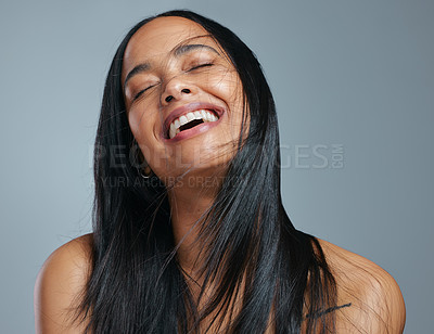 Buy stock photo Studio shot of an attractive young woman posing against a grey background