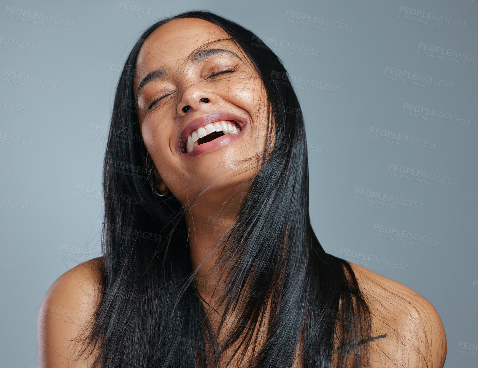 Buy stock photo Studio shot of an attractive young woman posing against a grey background