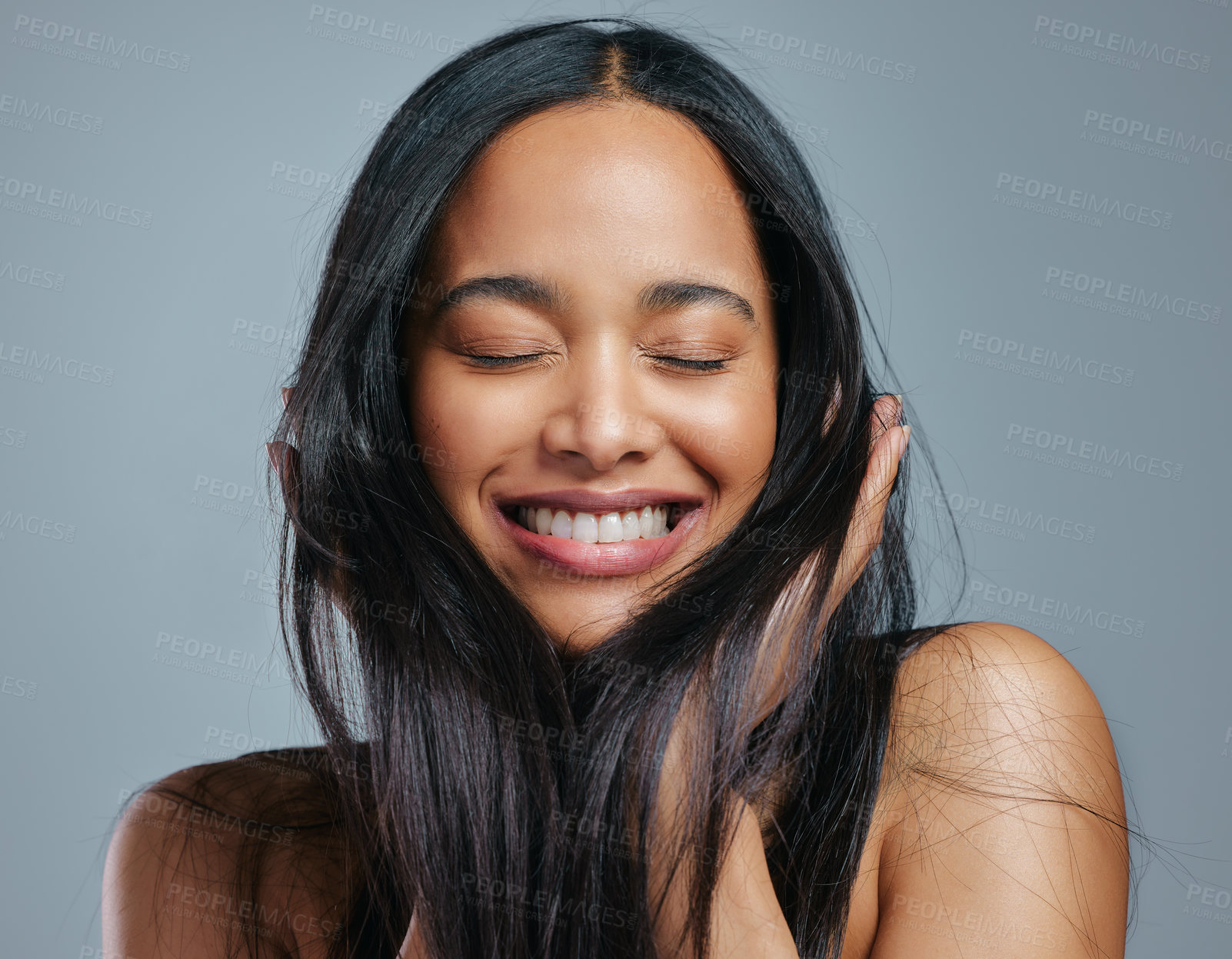 Buy stock photo Studio shot of an attractive young woman posing against a grey background