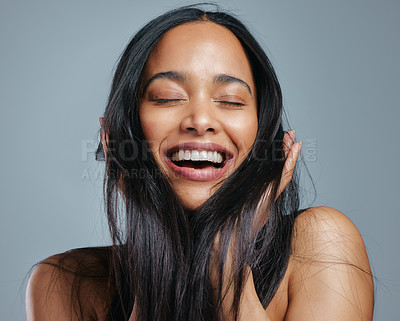 Buy stock photo Studio shot of an attractive young woman posing against a grey background