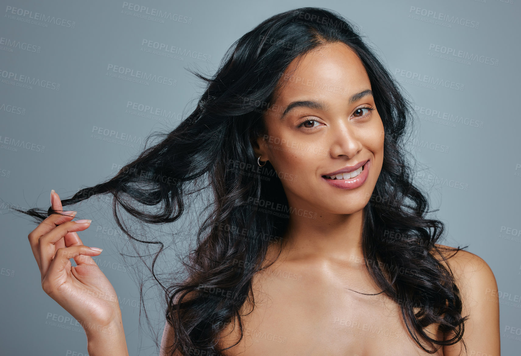 Buy stock photo Studio portrait of an attractive young woman posing against a grey background