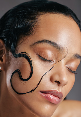 Buy stock photo Studio shot of an attractive young woman posing with a strand of wet hair on her face