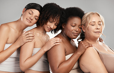 Buy stock photo Shot of a diverse group of women standing close together in the studio and posing