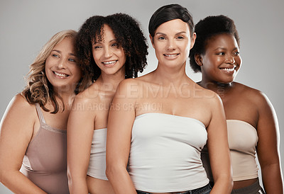 Buy stock photo Shot of a diverse group of women standing close together in the studio and posing