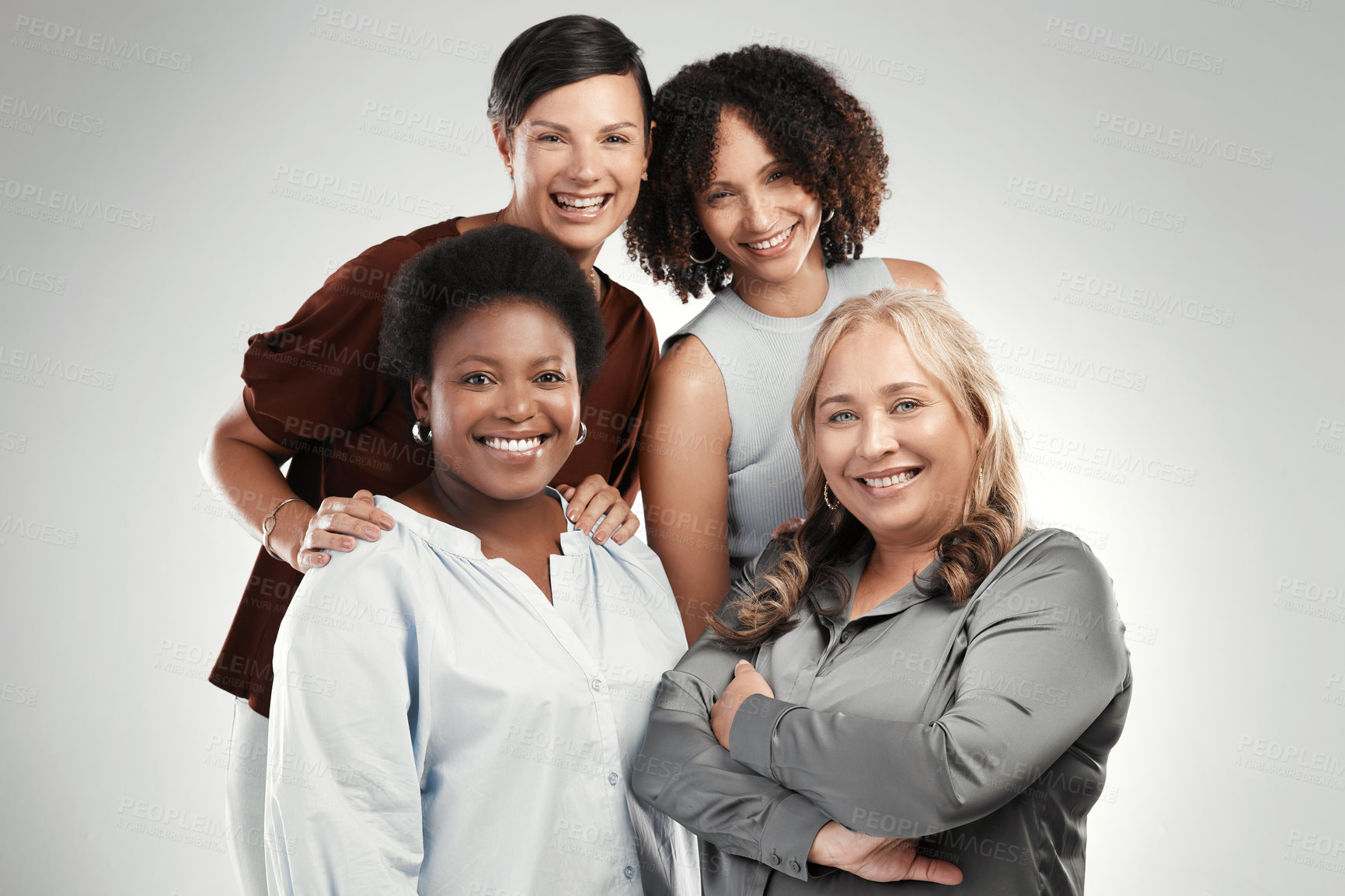 Buy stock photo Shot of a diverse group of women standing close together in the studio and posing