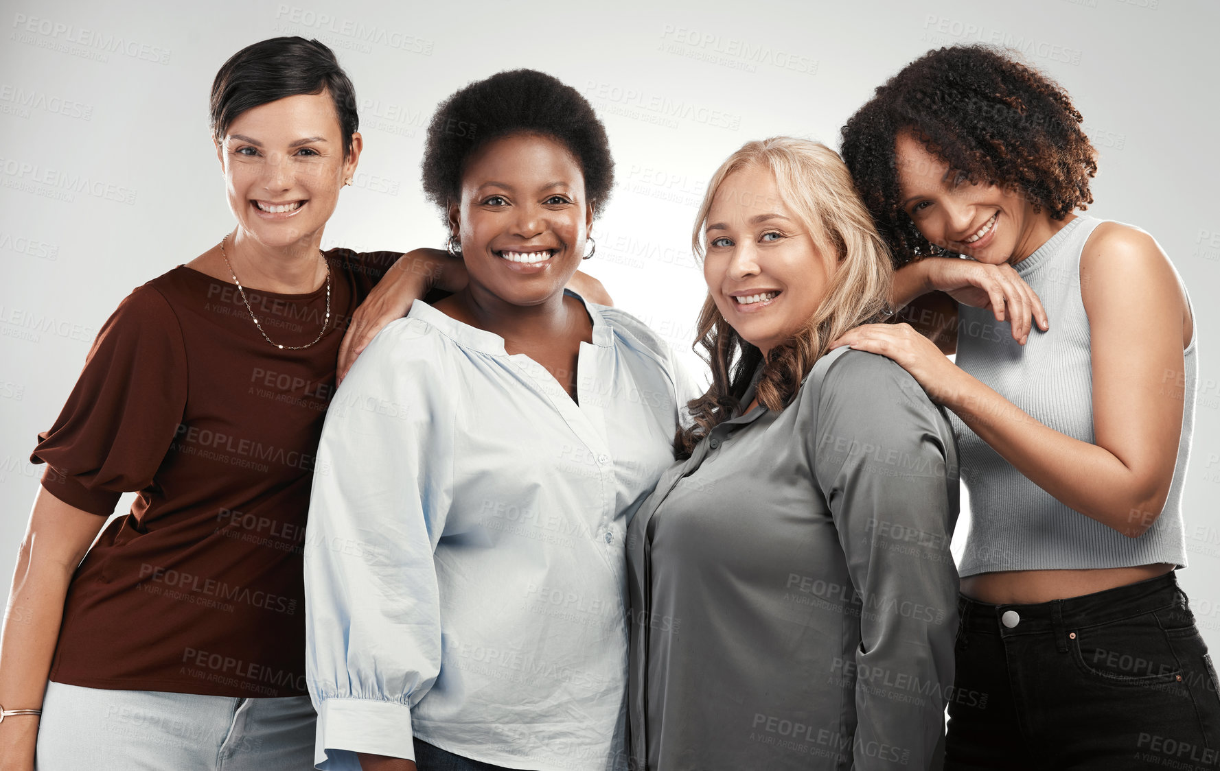 Buy stock photo Shot of a diverse group of women standing close together in the studio and posing