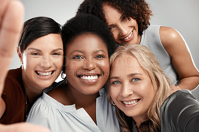 Buy stock photo Shot of a diverse group of women standing close together in the studio and take a selfie