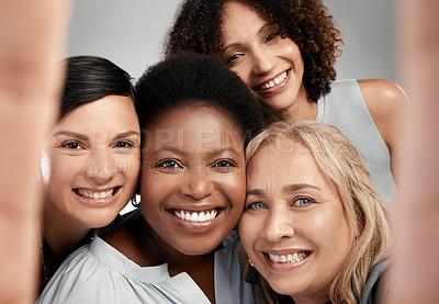 Buy stock photo Shot of a diverse group of women standing close together in the studio and take a selfie