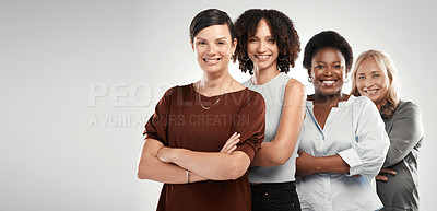 Buy stock photo Shot of a diverse group of women standing together in the studio with their arms folded