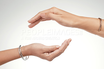 Buy stock photo Cropped shot of  two unrecognizable women posing with their hands cupped above each other