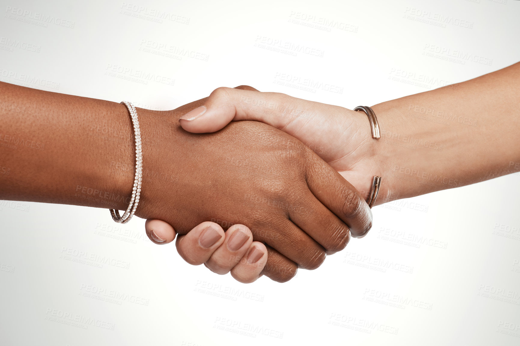 Buy stock photo Cropped shot of two unrecognizable women shaking hands in the studio