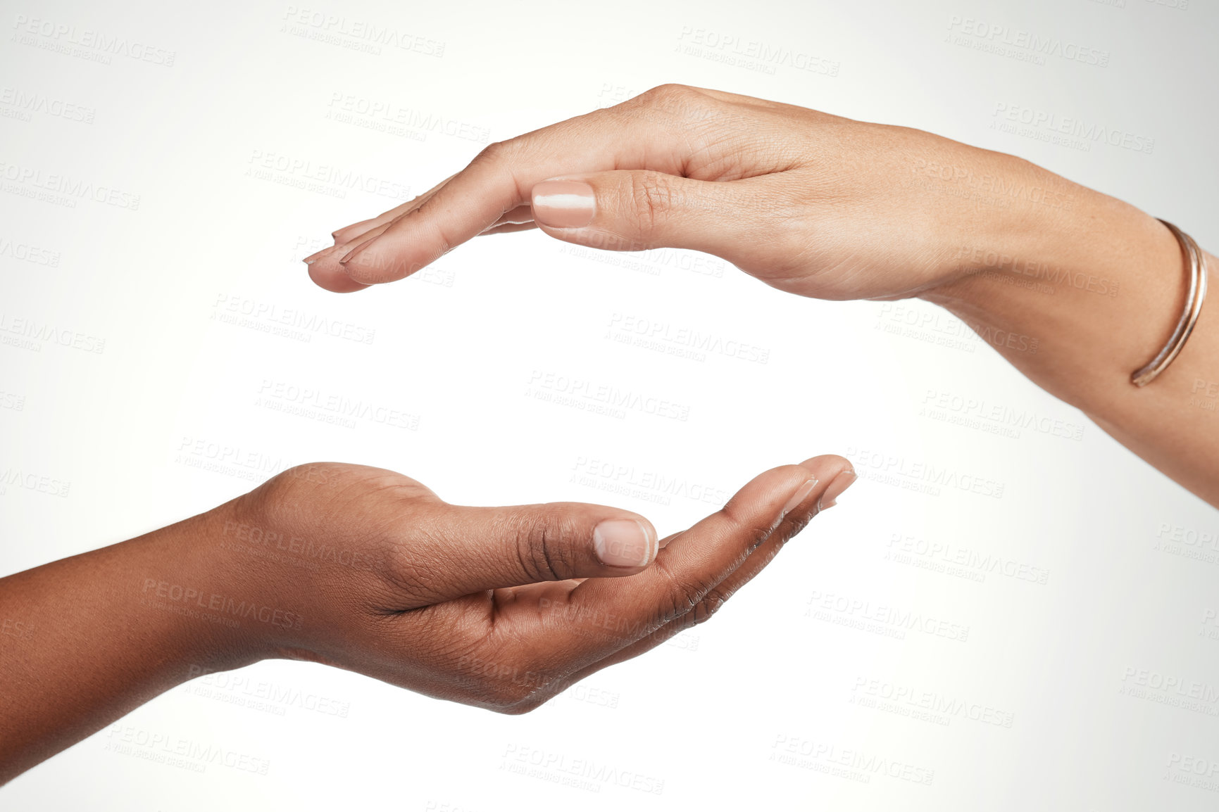 Buy stock photo Cropped shot of two unrecognizable women posing with their hands cupped above each other