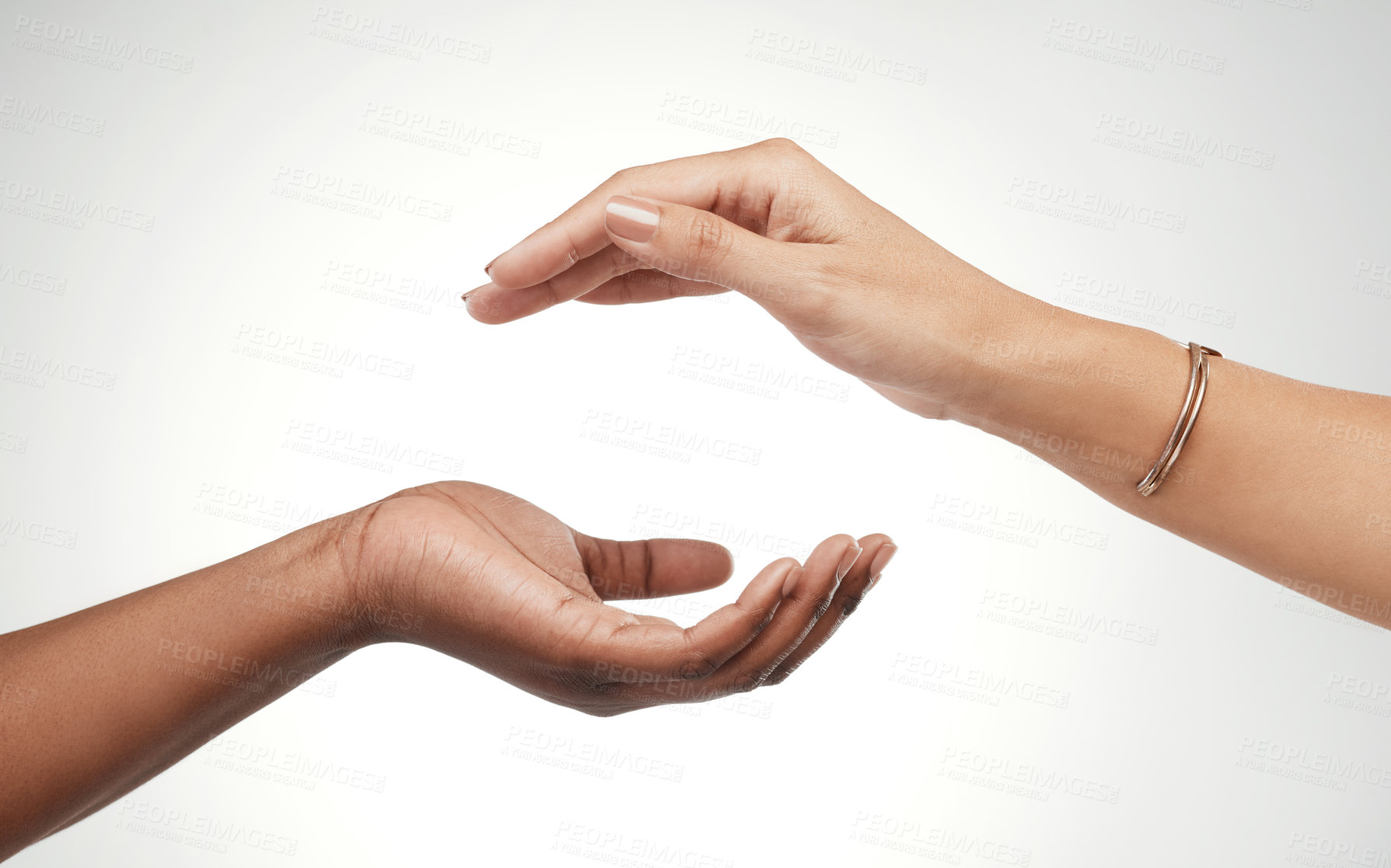 Buy stock photo Cropped shot of two unrecognizable women posing with their hands cupped above each other