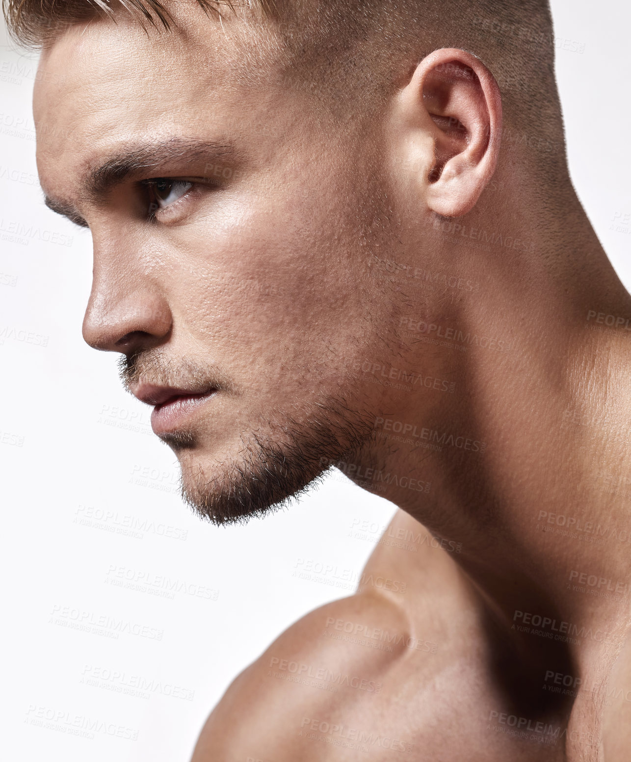 Buy stock photo Cropped shot of a handsome young man posing against a white background