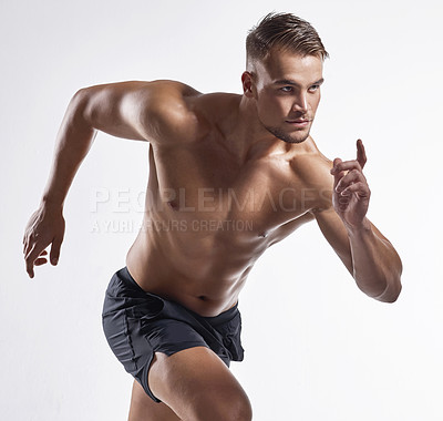 Buy stock photo Shot of an athletic young man posing against a white background