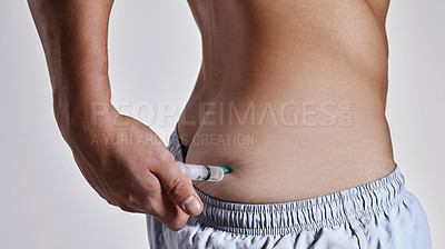 Buy stock photo Cropped shot of a man injecting himself on his buttock