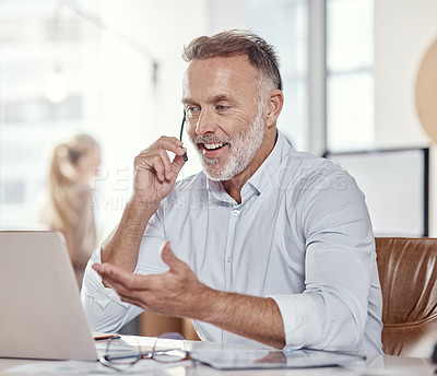 Buy stock photo Shot of a mature man using a headset and laptop in a modern office