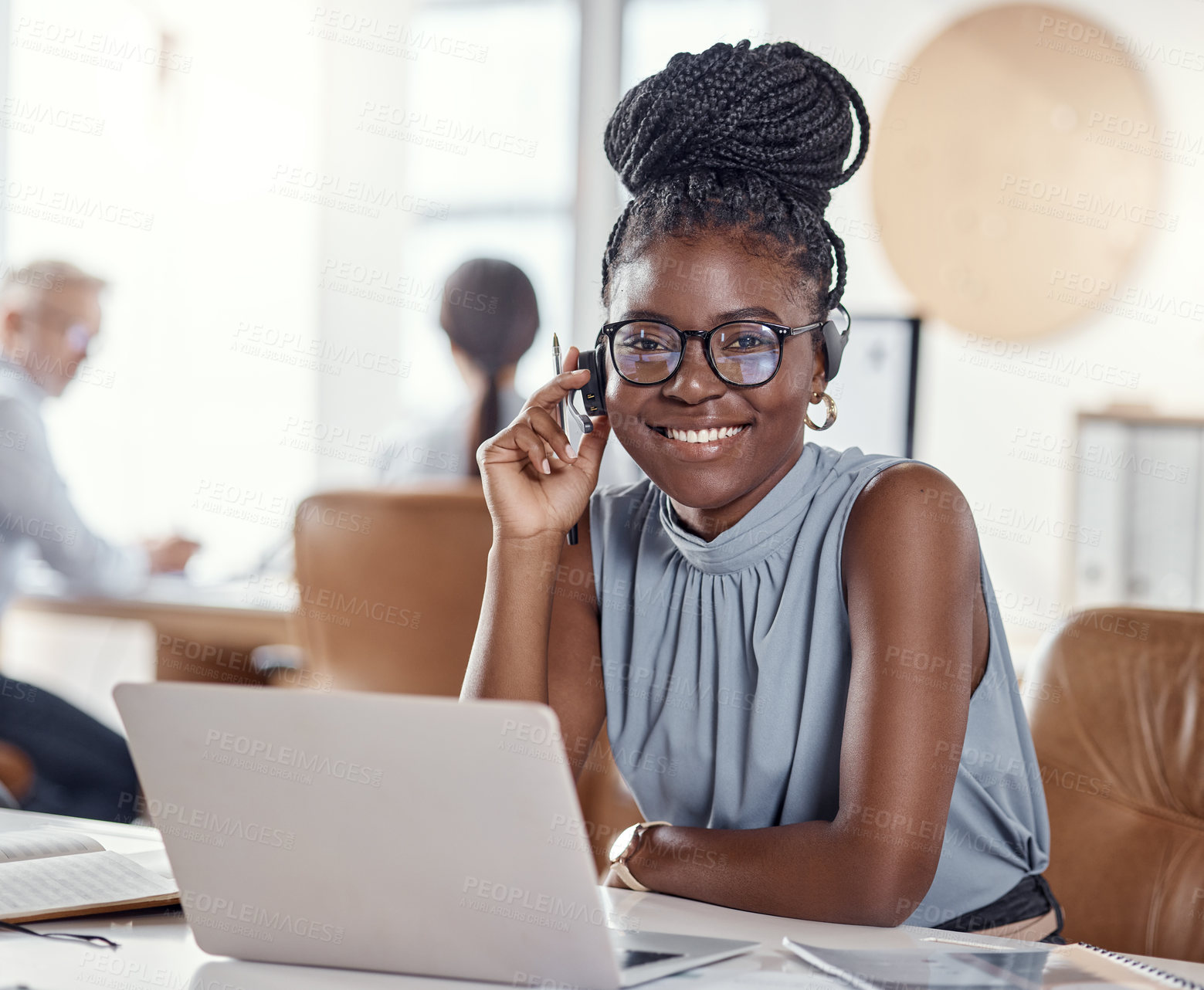 Buy stock photo Shot of a young woman using a headset and laptop in a modern office