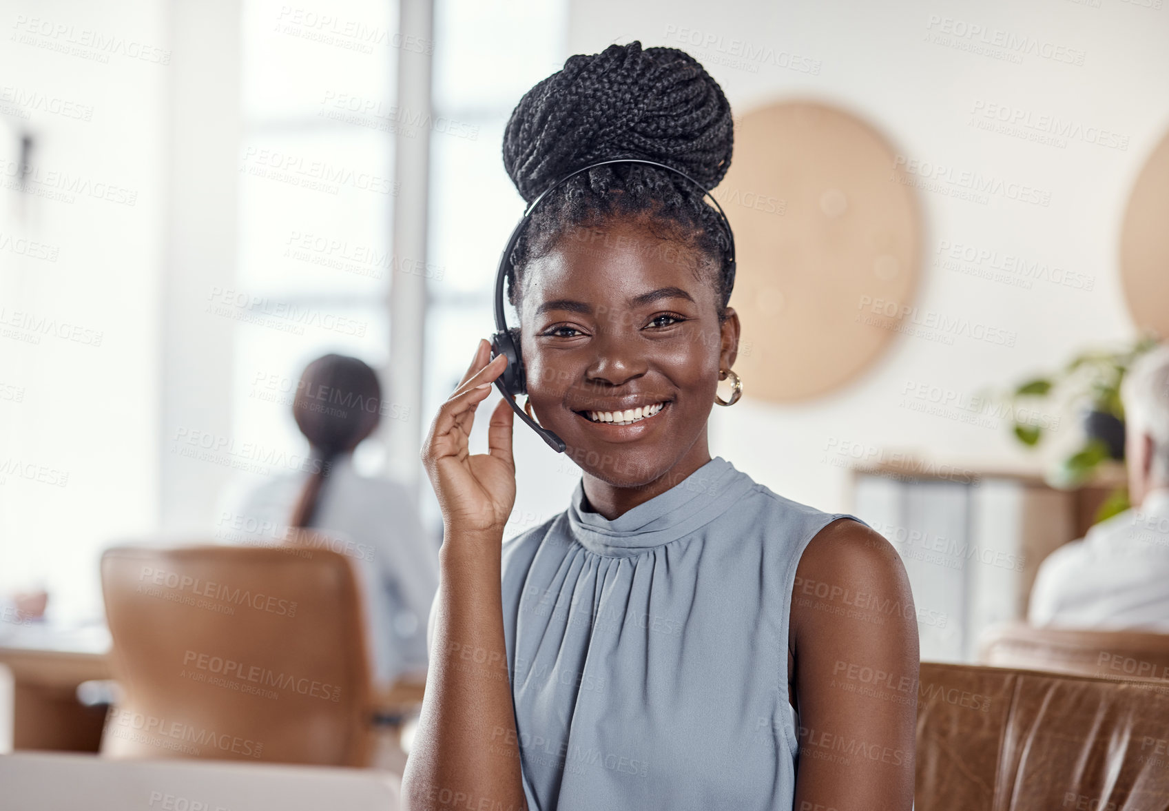 Buy stock photo Shot of a young woman using a headset and laptop in a modern office