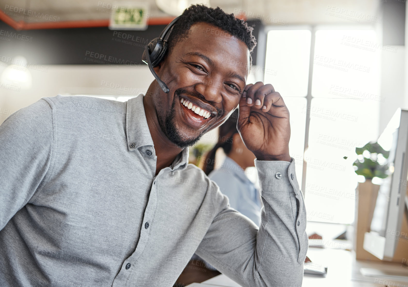 Buy stock photo Portrait of a young man using a headset in a modern office