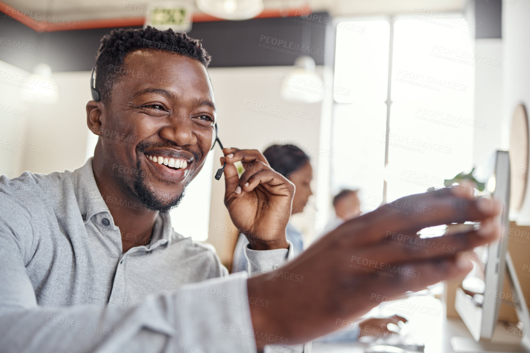 Buy stock photo Shot of a young man using a headset in a modern office