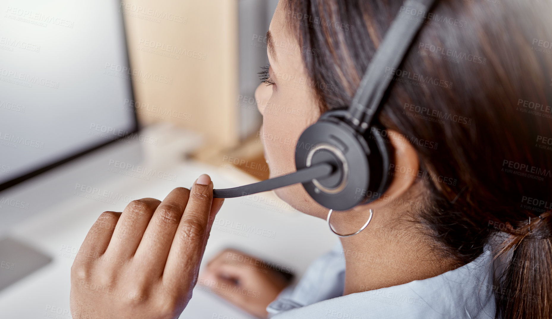 Buy stock photo Shot of a woman using a headset and laptop in a modern office