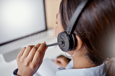 Buy stock photo Shot of a woman using a headset and laptop in a modern office