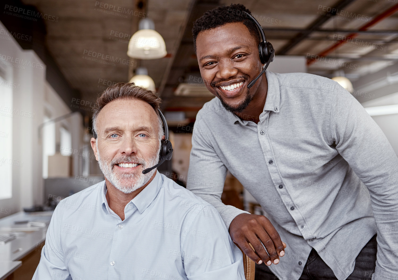 Buy stock photo Portrait of two men using headsets in a modern office