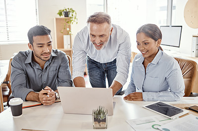 Buy stock photo Shot of a group of businesspeople using a laptop in a modern office