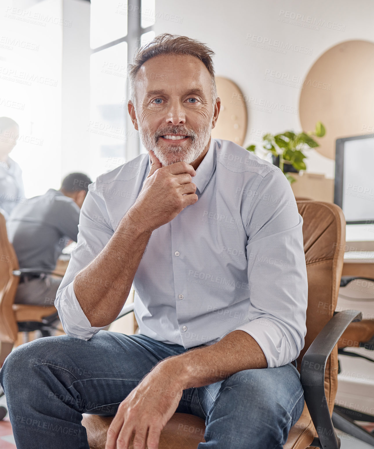 Buy stock photo Portrait of a confident mature businessman working in a modern office