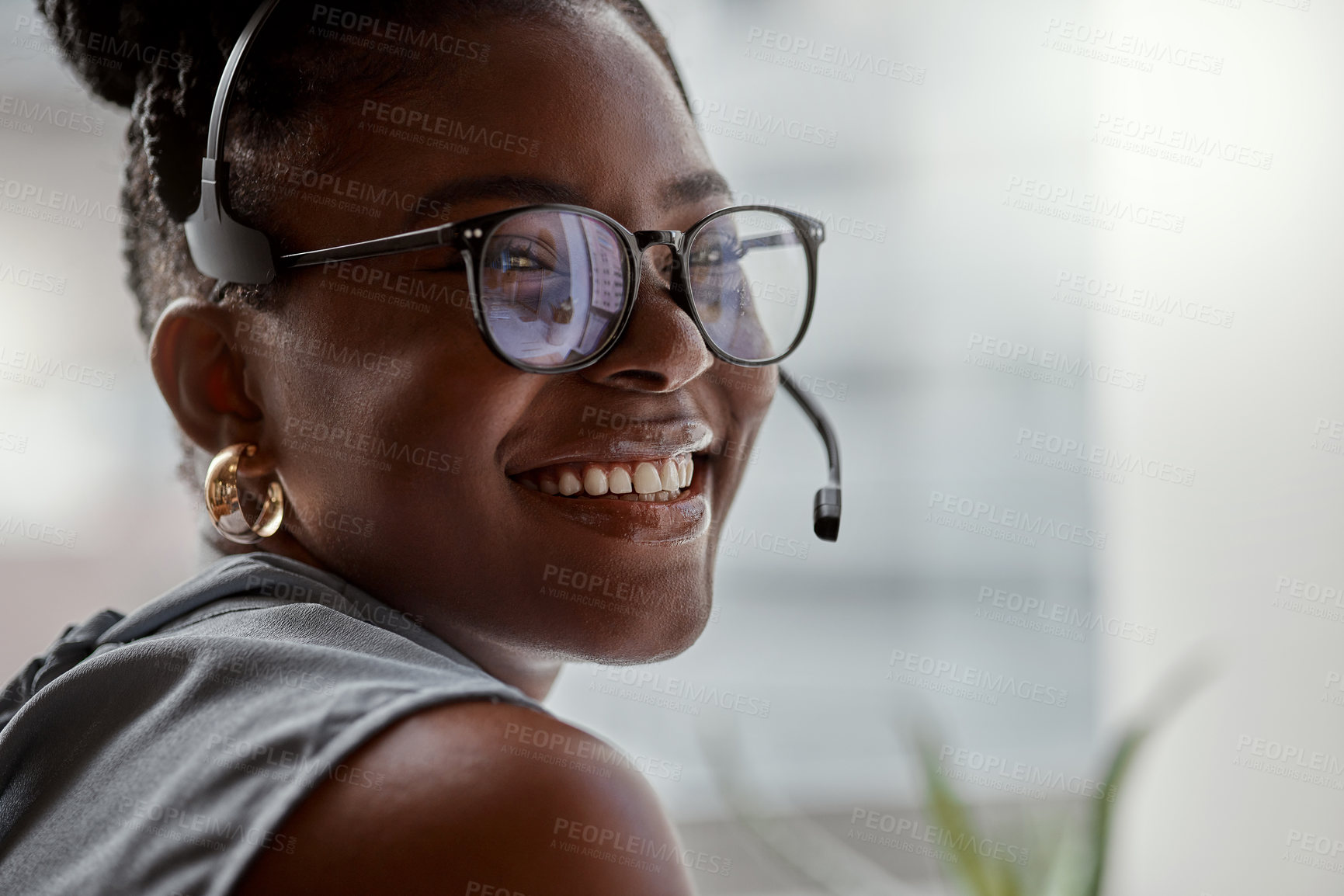 Buy stock photo Shot of a young woman using a headset in a modern office