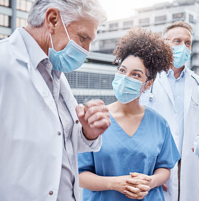 Buy stock photo Shot of two doctors talking in the city
