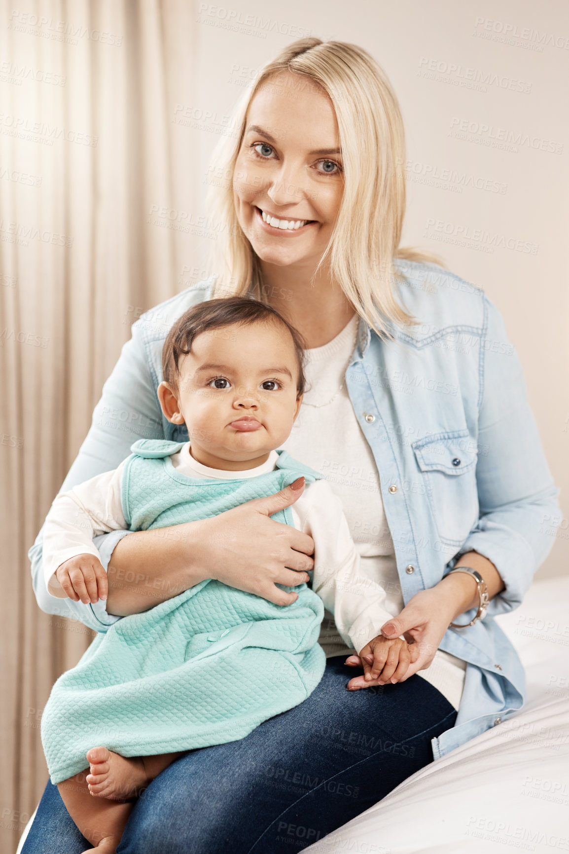 Buy stock photo Shot of a woman bonding with her baby girl at home