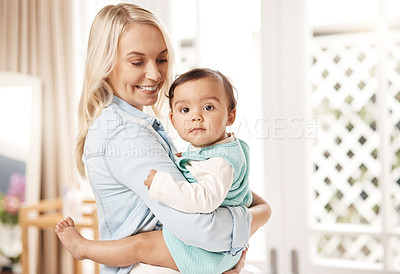 Buy stock photo Shot of a woman bonding with her baby girl at home