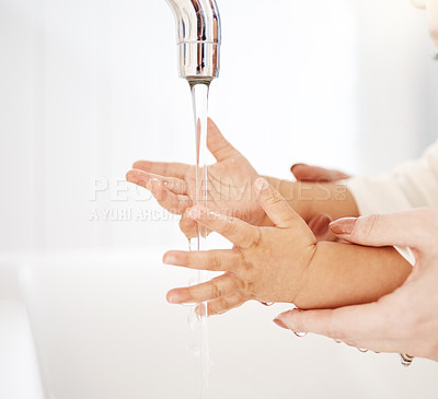 Buy stock photo Cropped shot of a woman washing her baby's hands