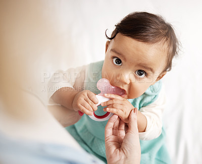 Buy stock photo Shot of an adorable little girl playing with a teething toy